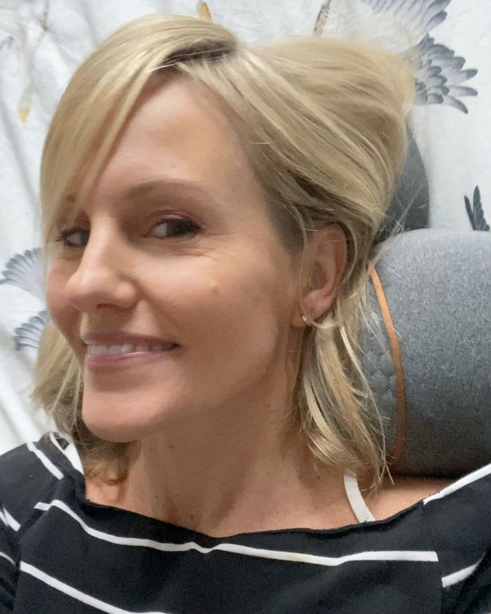 A smiling customer lying back on the FisioRest.