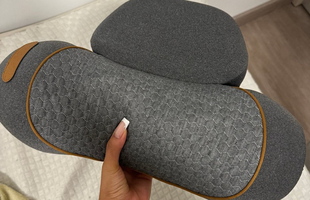 A customer photograph of a hand gripping the FisioRest, both padded lobes visible.